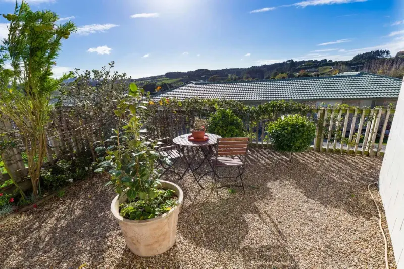 Private gravel courtyard with table and chairs